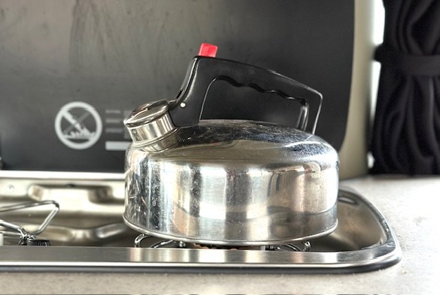 A whistling kettle on a gas hob